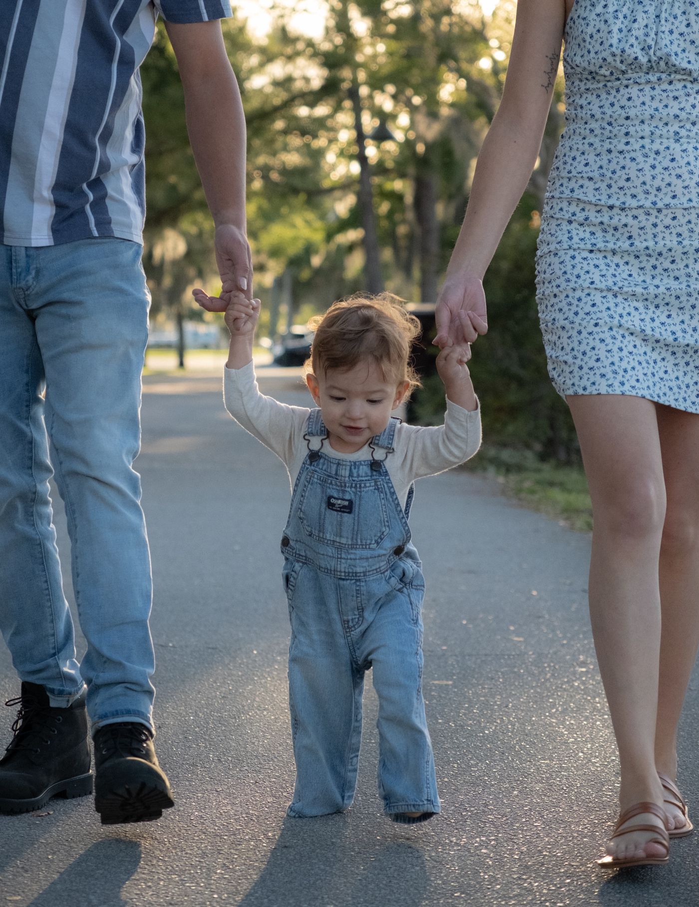 Parents walking with their child in a park — reference photograph by Anastasia Nagibina